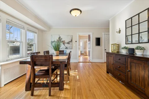 a view of a dining room with furniture and a window