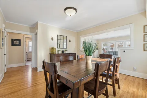 a dining room with furniture and wooden floor