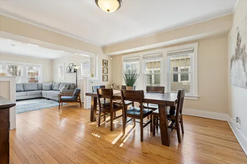 a view of a dining room with furniture and wooden floor