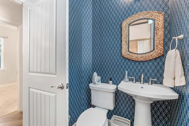 a bathroom with a toilet a sink and a mirror