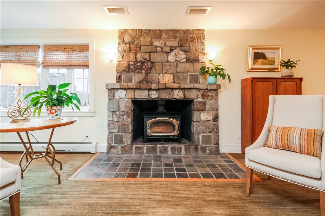 55 What Cheer Road Narragansett, RI 02882 - Photo 5 of 20 Striking Stone Fireplace with recessed wood stove
