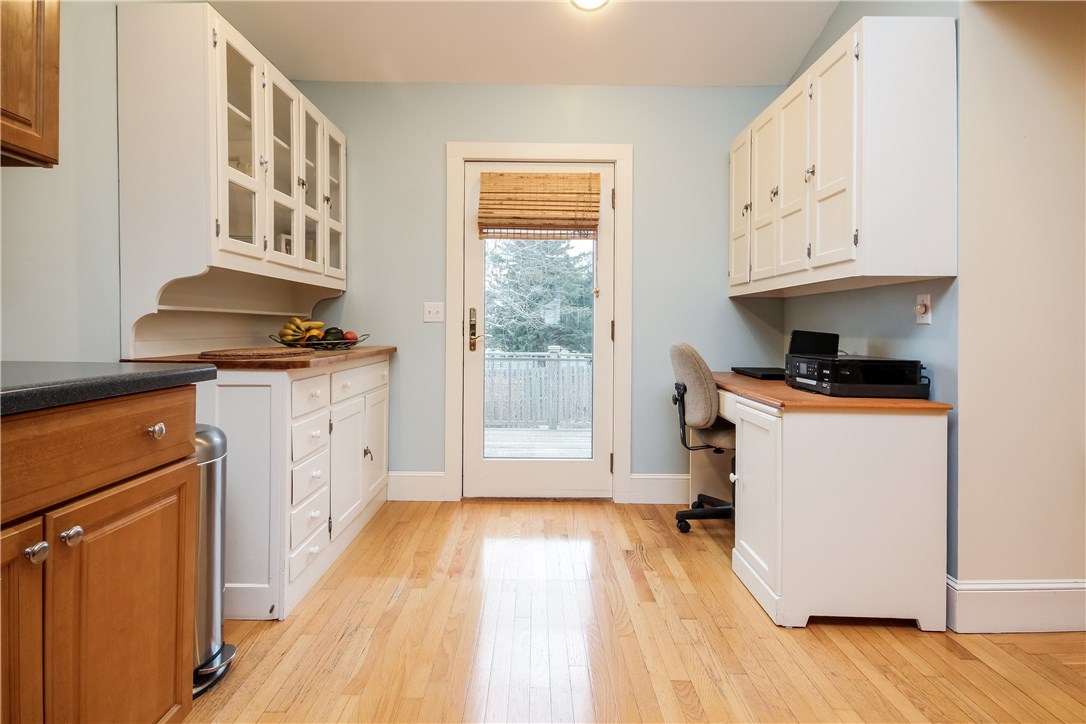 55 What Cheer Road Narragansett, RI 02882 - Photo 9 of 20 Charming cabinetry in kitchen for storage, display and convenient desk area. Full view door to deck