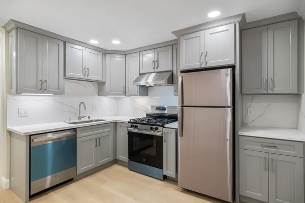 a kitchen with a sink stove and refrigerator