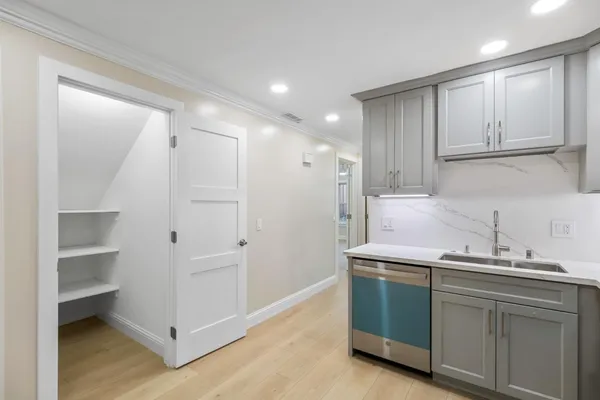 a kitchen with a sink cabinets and stainless steel appliances