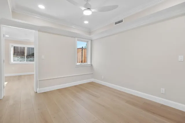 wooden floor in an empty room with a window