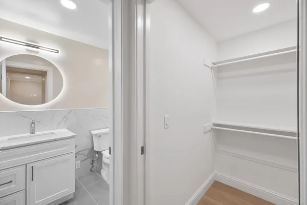 a bathroom with a sink vanity and a mirror
