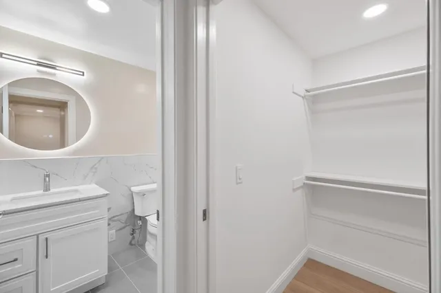 a bathroom with a sink vanity and a mirror
