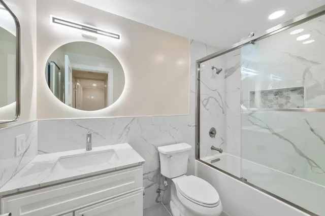 a bathroom with a sink a toilet and a mirror