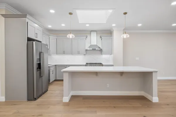 a view of kitchen with center island and stainless steel appliances