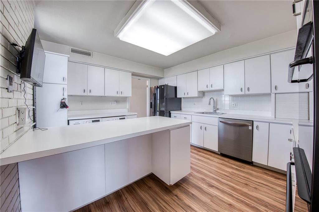 552 North Neville Street, Unit PH2 Pittsburgh, PA 15213 - Photo 12 of 42 a kitchen with a sink a microwave a stove and cabinets
