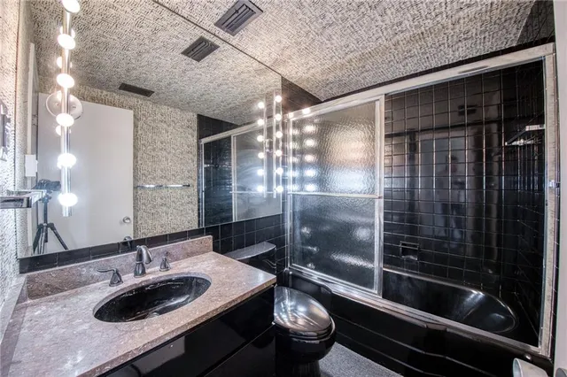 a living room with stainless steel appliances kitchen island granite countertop furniture and a fireplace