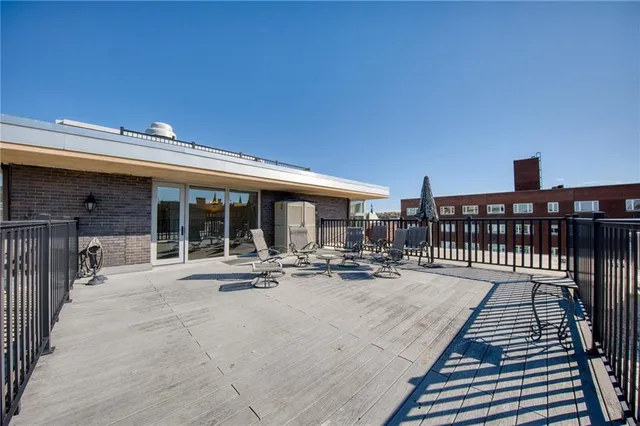 a view of house with swimming pool and sitting area