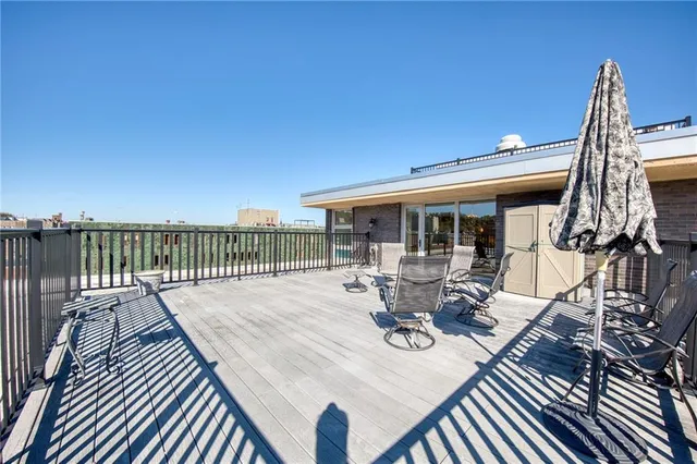 a view of a roof deck with wooden floor and seating space