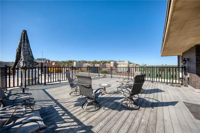 a view of a balcony with seating space