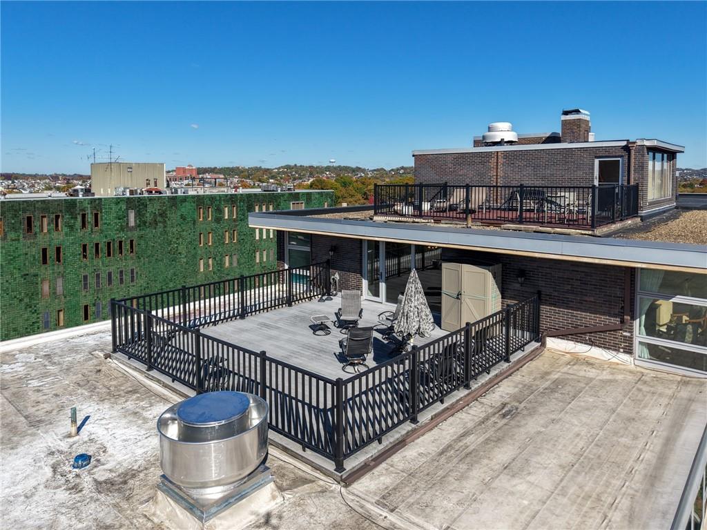 552 North Neville Street, Unit PH2 Pittsburgh, PA 15213 - Photo 32 of 42 a roof deck with table and chairs a barbeque