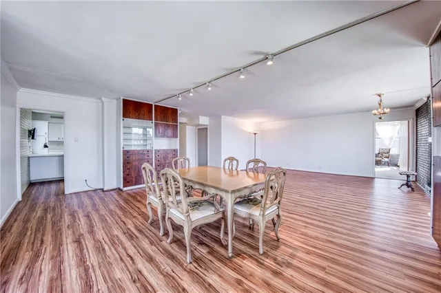 a view of a livingroom with furniture wooden floor ceiling fan and windows