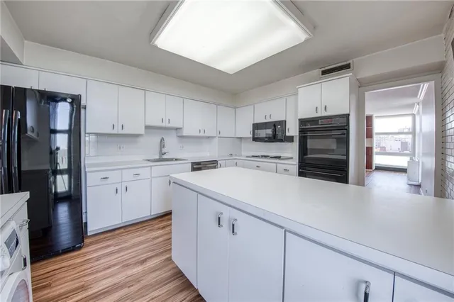 a kitchen with a sink stove and refrigerator