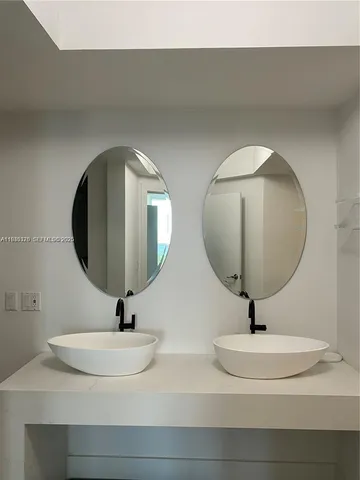 a bathroom with a sink and mirror