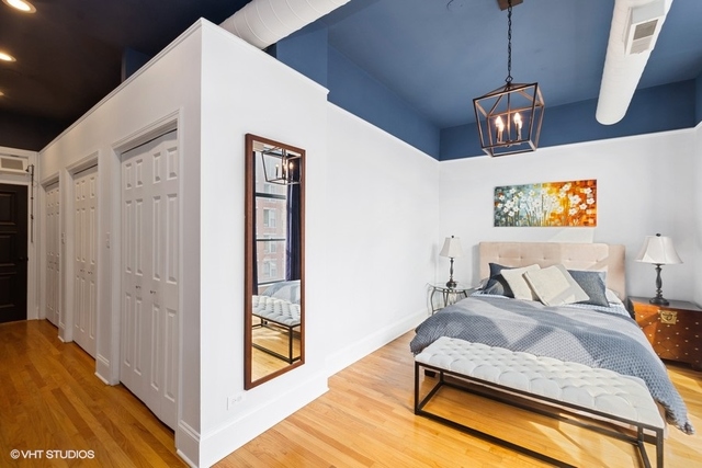 1016 West Madison Street, Unit 3S Chicago, IL 60607 - Photo 14 of 22 a bedroom with bed and wooden floor