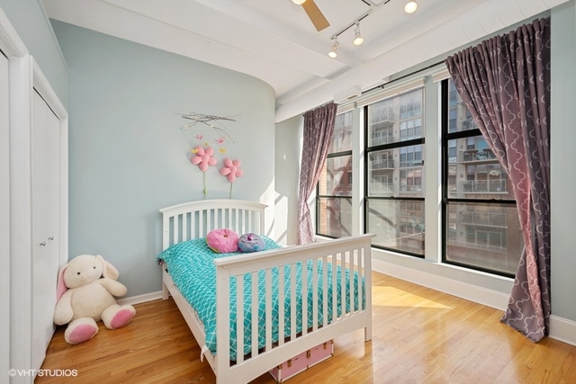 1016 West Madison Street, Unit 3S Chicago, IL 60607 - Photo 17 of 22 a bedroom with furniture and a large window