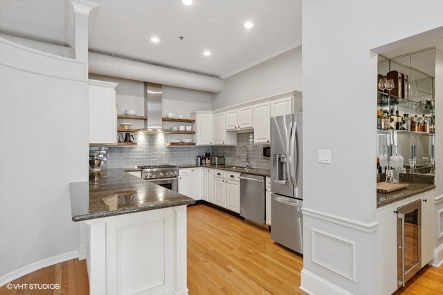 1016 West Madison Street, Unit 3S Chicago, IL 60607 - Photo 8 of 22 a kitchen with stainless steel appliances granite countertop a refrigerator and a stove top oven