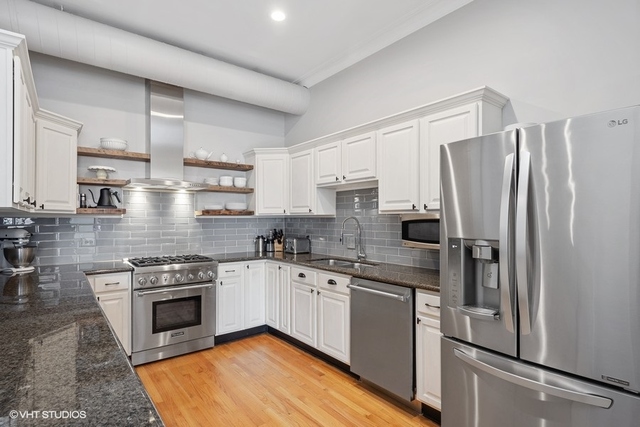 1016 West Madison Street, Unit 3S Chicago, IL 60607 - Photo 9 of 22 a kitchen with stainless steel appliances granite countertop a stove top oven a refrigerator and a sink