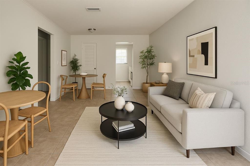 1217 Kennedy Road, Unit 56 Daytona Beach, FL 32117 - Photo 3 of 9 a living room with furniture and a mirror
