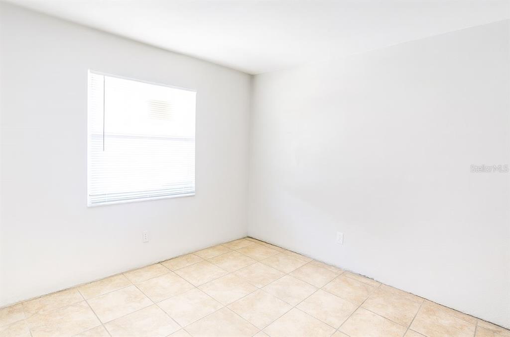 1217 Kennedy Road, Unit 56 Daytona Beach, FL 32117 - Photo 5 of 9 an empty room with a window