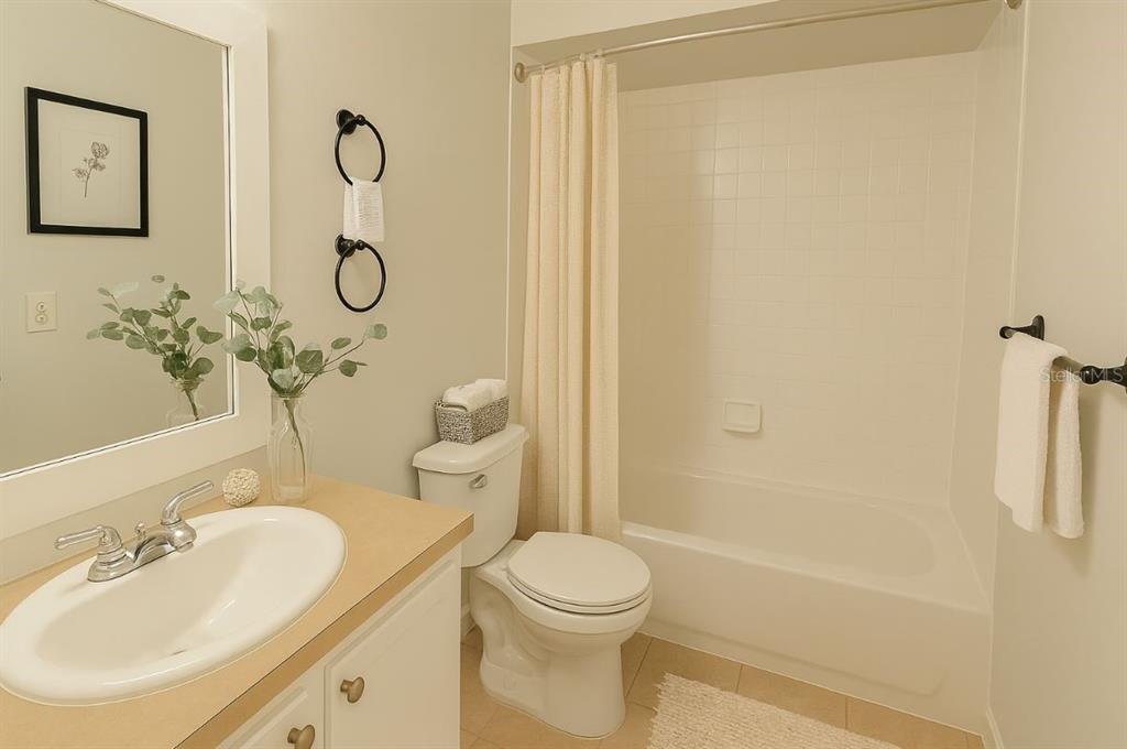 1217 Kennedy Road, Unit 56 Daytona Beach, FL 32117 - Photo 7 of 9 a bathroom with a sink a toilet and shower