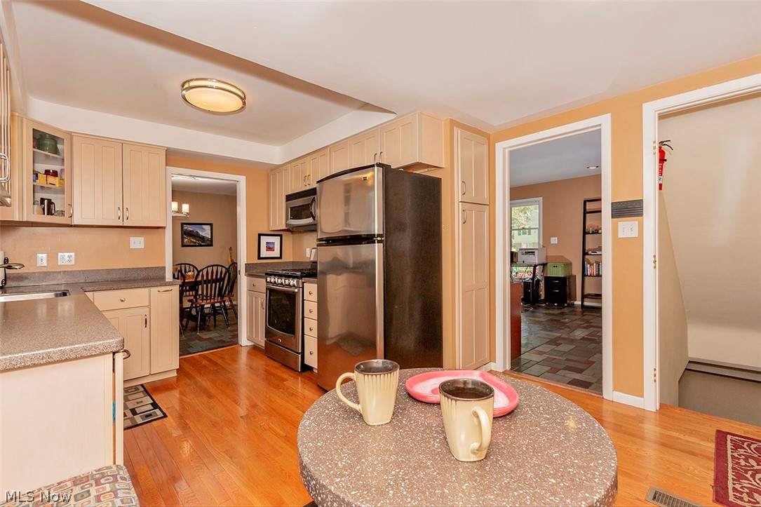 22025 Rye Road Beachwood, OH 44122 - Photo 6 of 34 Hardwood floors in eat in kitchen with stainless steel appliances.