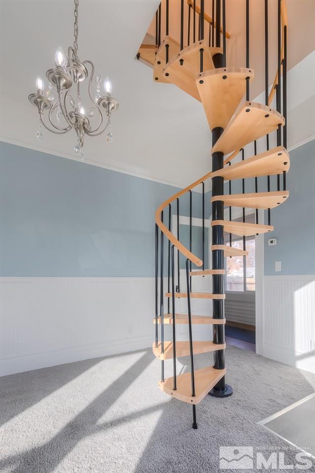 614 Elko Avenue Reno, NV 89512 - Photo 6 of 24 a view of staircase with white walls and chandelier