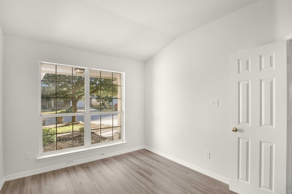 3310 Blue Ridge Drive Round Rock, TX 78681 - Photo 9 of 13 A window-filled room with vaulted ceilings and durable wood-look flooring.