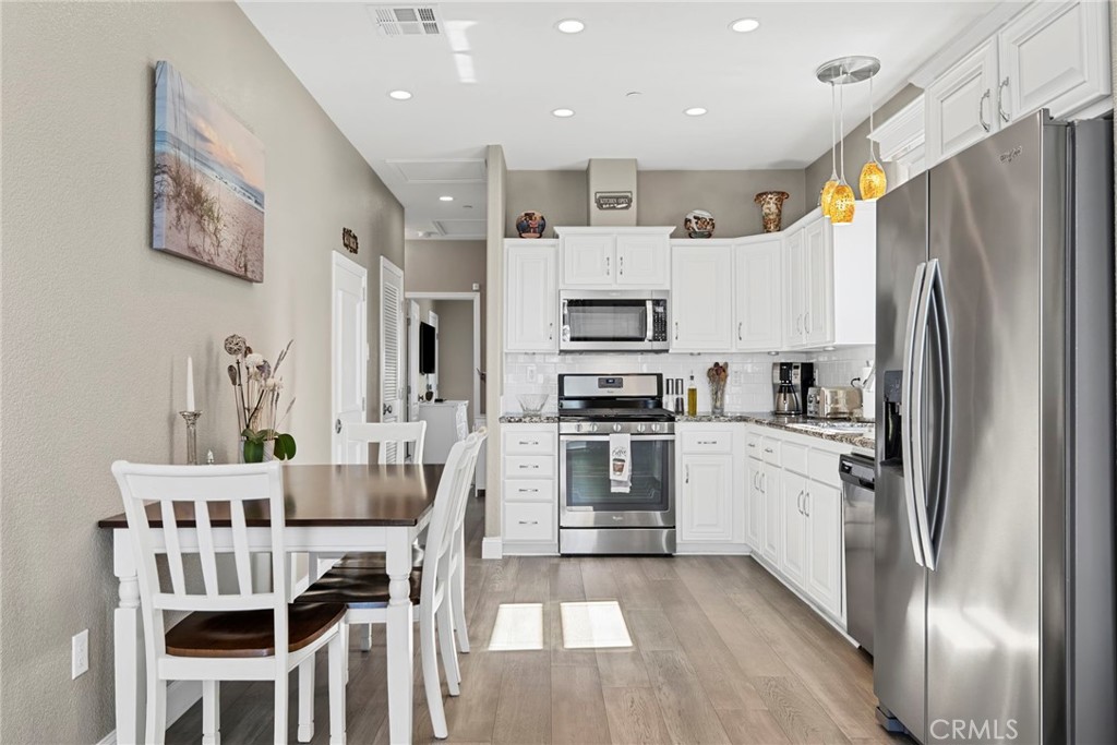 48 Riversea Road Seal Beach, CA 90740 - Photo 12 of 34 a kitchen with stainless steel appliances kitchen island granite countertop a refrigerator and a stove top oven