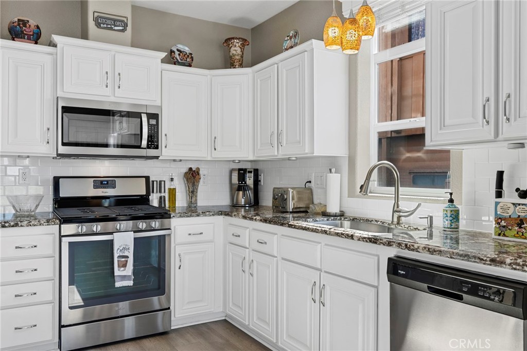 48 Riversea Road Seal Beach, CA 90740 - Photo 16 of 34 a kitchen with granite countertop white cabinets and stainless steel appliances