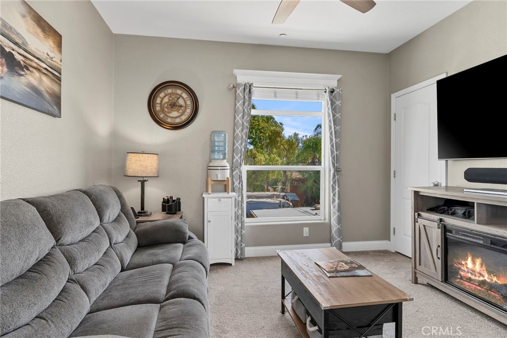 48 Riversea Road Seal Beach, CA 90740 - Photo 25 of 34 a living room with furniture a clock and a flat screen tv