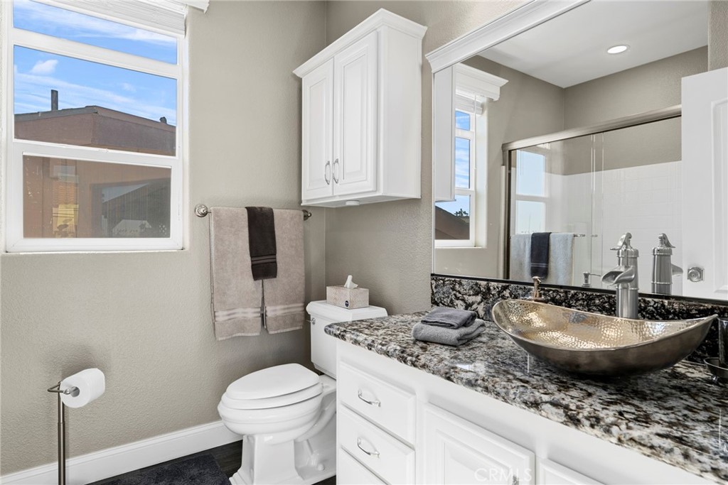 48 Riversea Road Seal Beach, CA 90740 - Photo 26 of 34 a bathroom with a granite countertop sink and a mirror