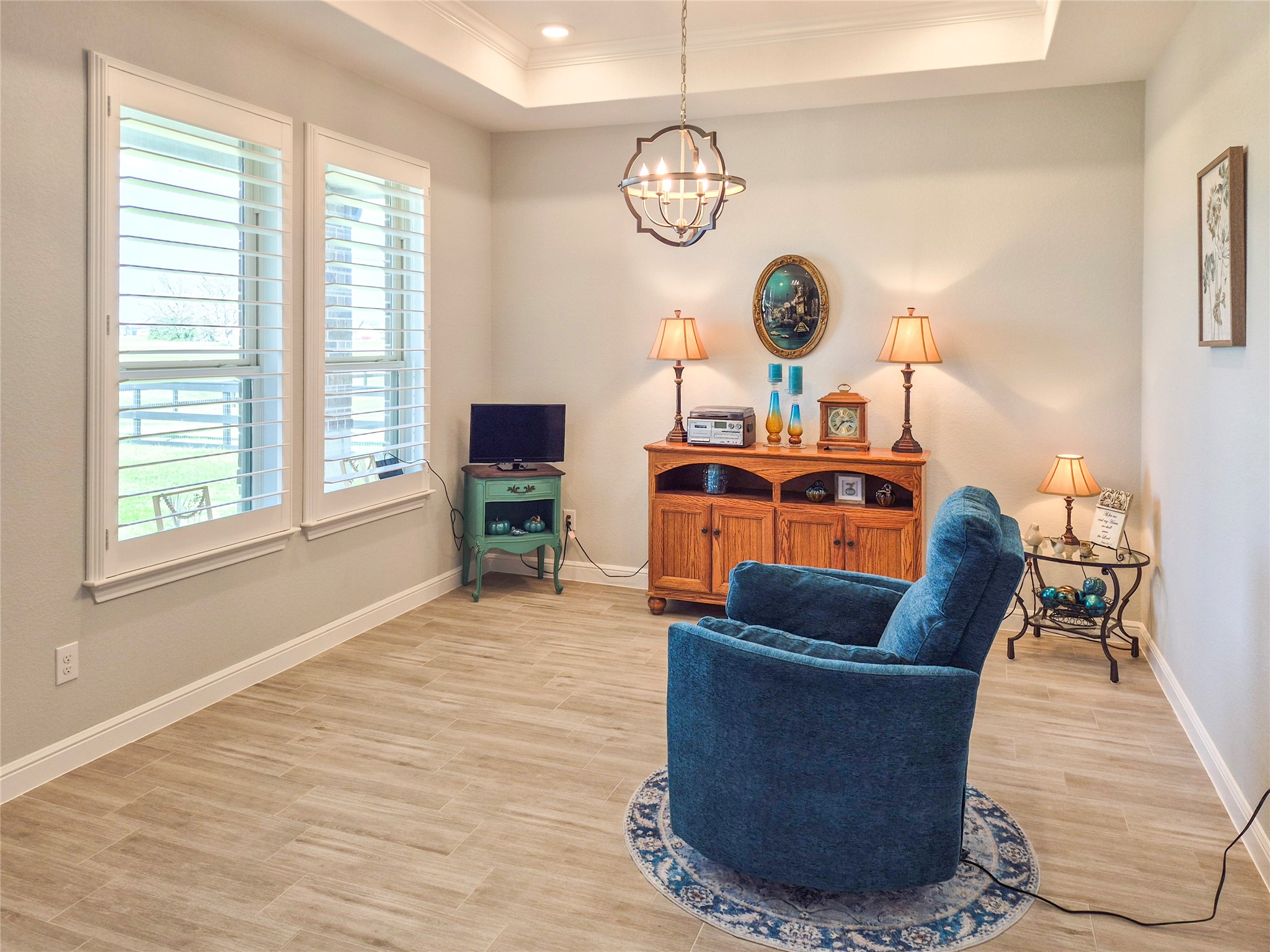 1325 Palomino Trail Angleton, TX 77515 - Photo 2 of 36 a living room with couches a dining table and a chandelier with wooden floor