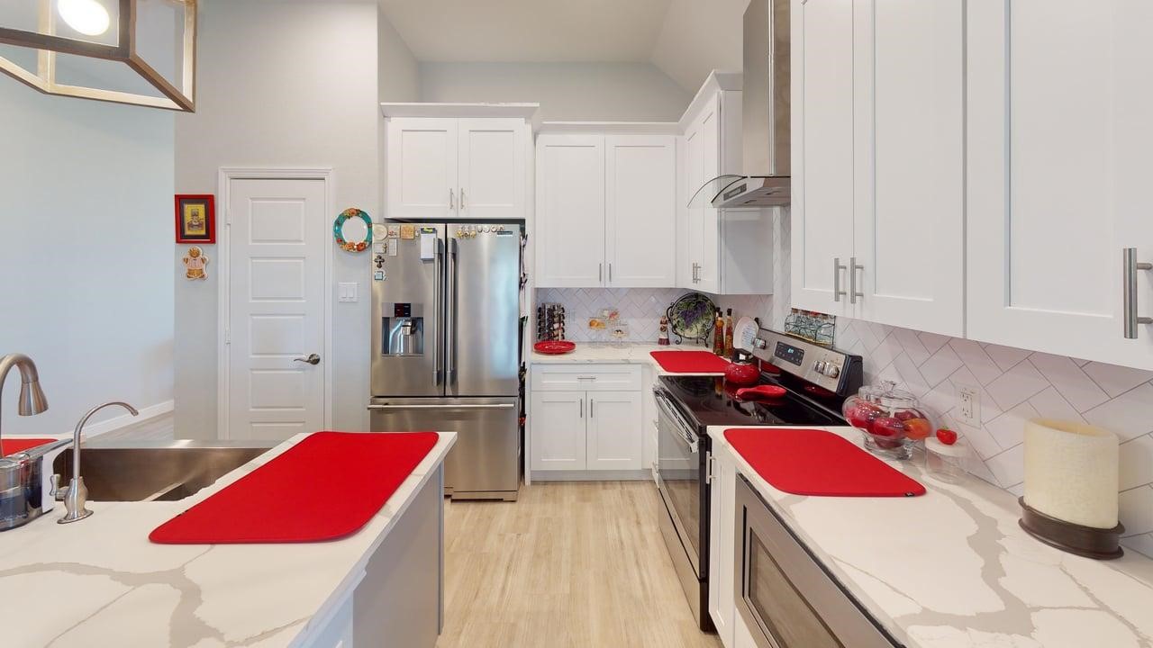 1325 Palomino Trail Angleton, TX 77515 - Photo 6 of 36 a kitchen with a refrigerator and a stove