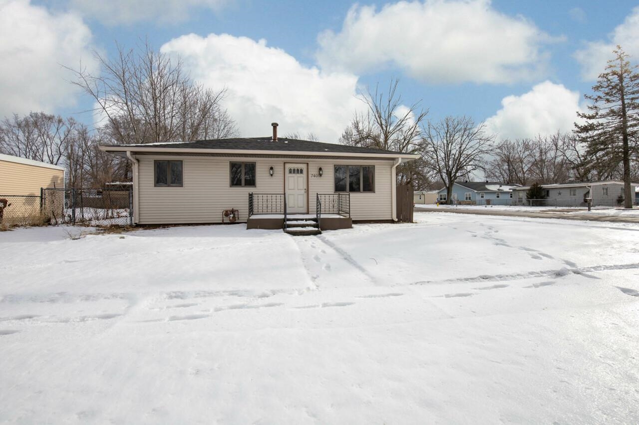 7401 Randy Road Machesney Park, IL 61115 - Photo 1 of 27 a view of a house with a snow in the yard