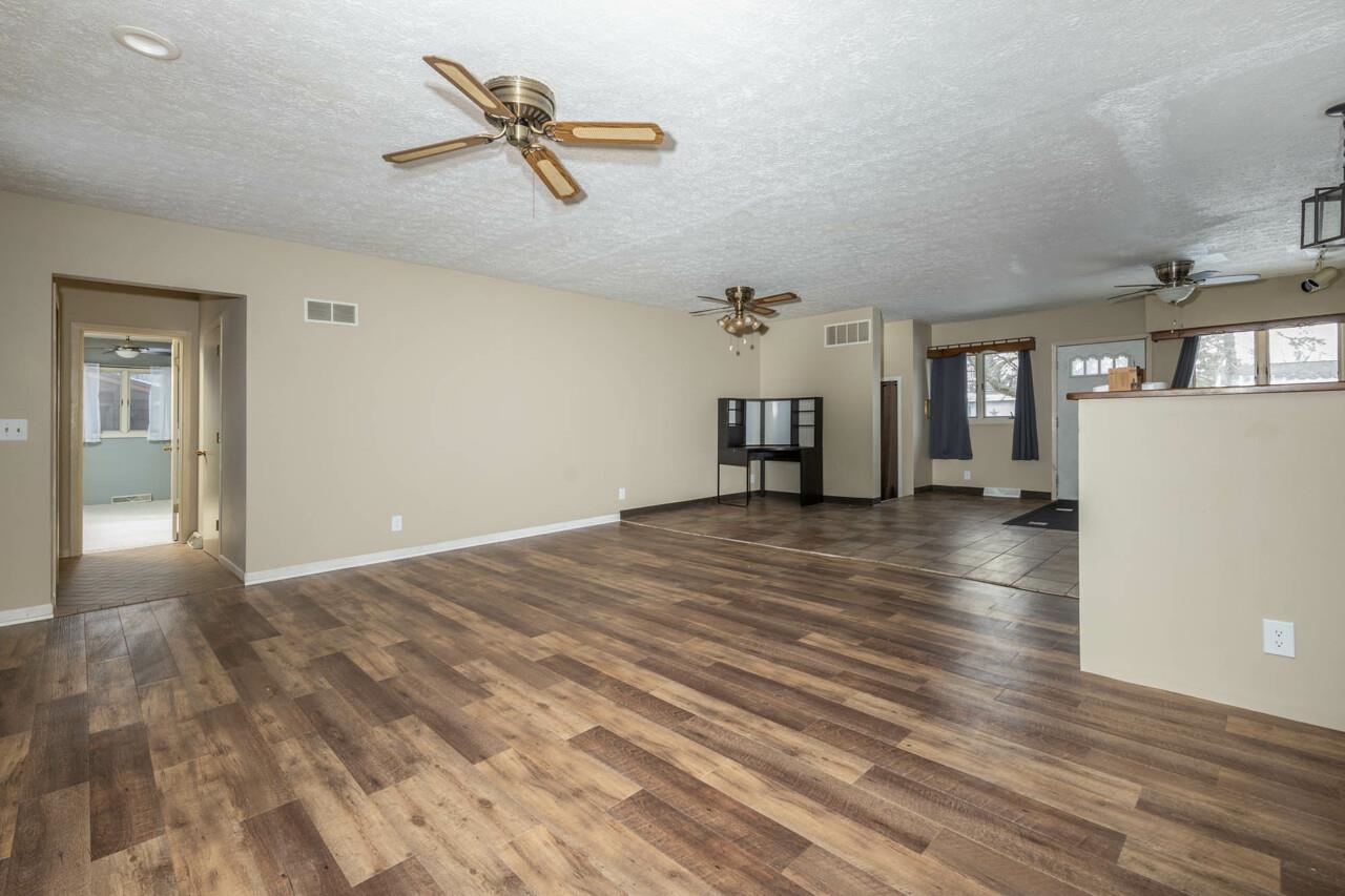 7401 Randy Road Machesney Park, IL 61115 - Photo 13 of 27 wooden floor in an empty room with a window