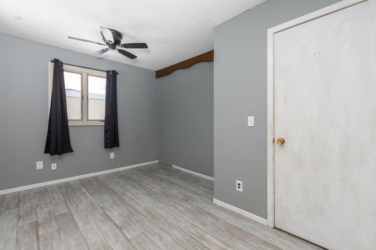 7401 Randy Road Machesney Park, IL 61115 - Photo 15 of 27 a view of empty room with wooden floor and fan
