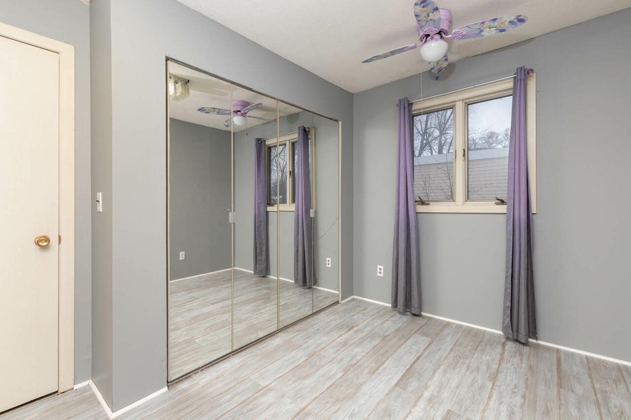 7401 Randy Road Machesney Park, IL 61115 - Photo 18 of 27 a view of a livingroom with a chandelier fan and windows