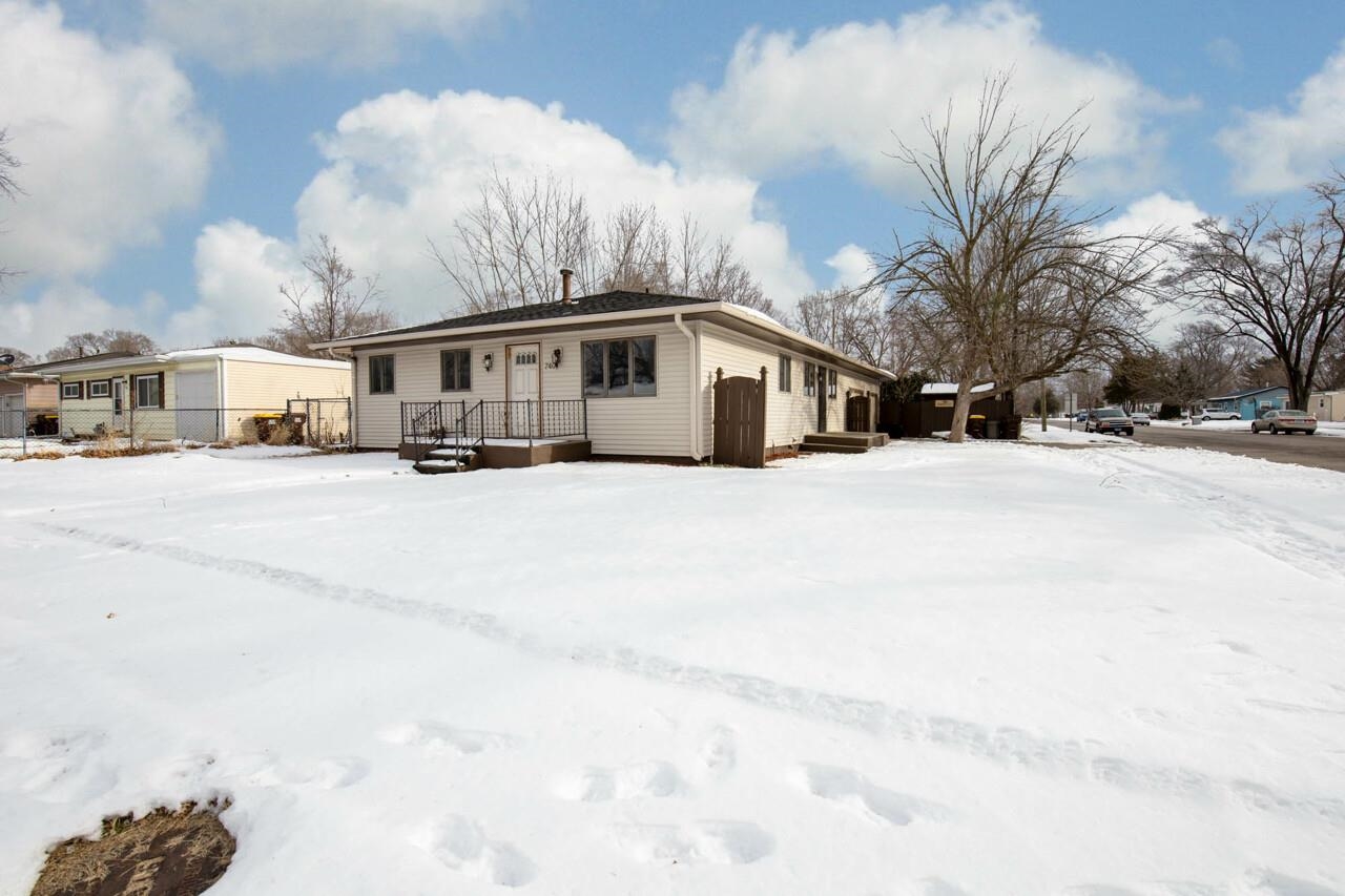7401 Randy Road Machesney Park, IL 61115 - Photo 2 of 27 a big house with a large tree in front of it