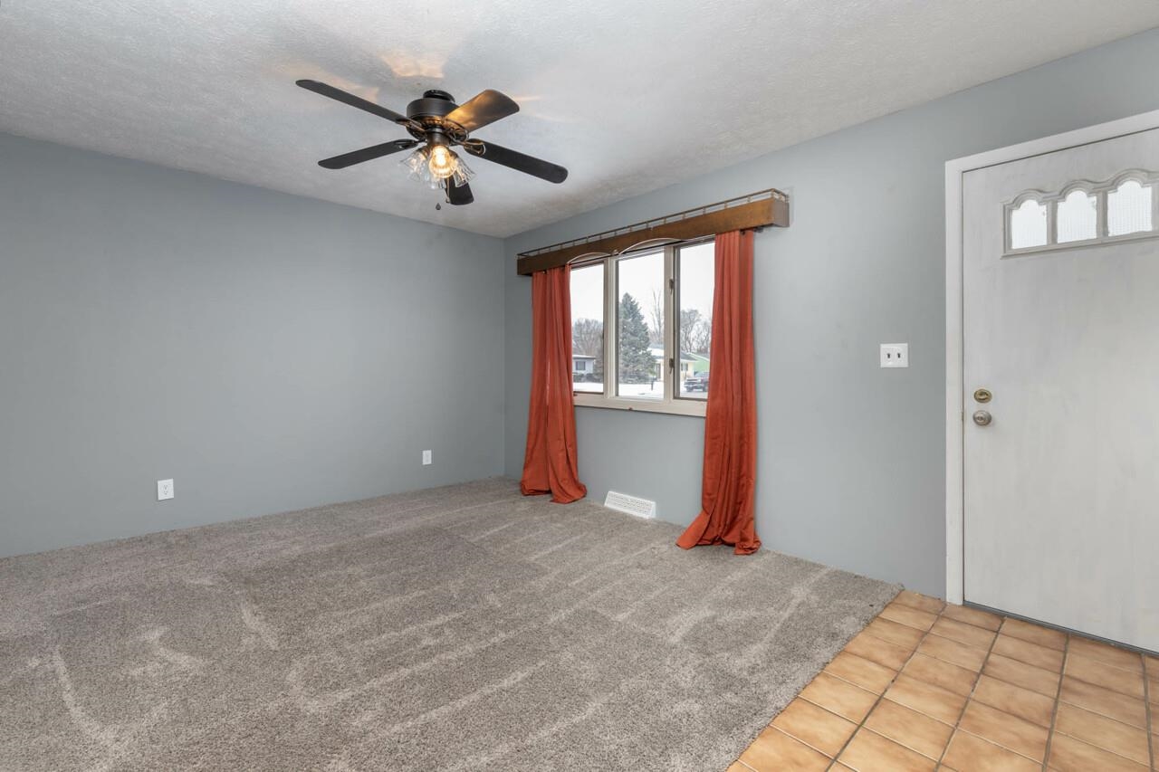 7401 Randy Road Machesney Park, IL 61115 - Photo 4 of 27 wooden floor in an empty room with a window
