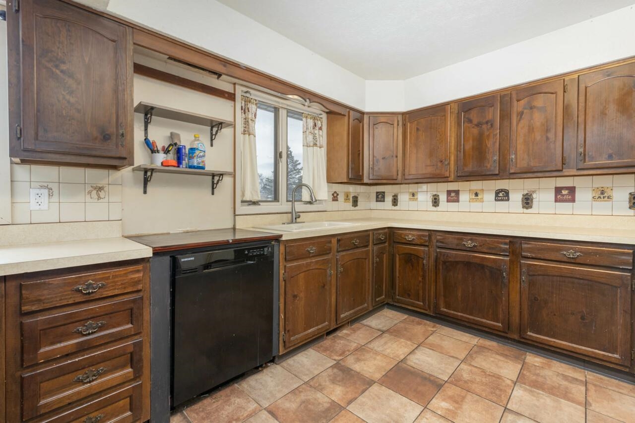 7401 Randy Road Machesney Park, IL 61115 - Photo 6 of 27 a kitchen with a sink cabinets and window