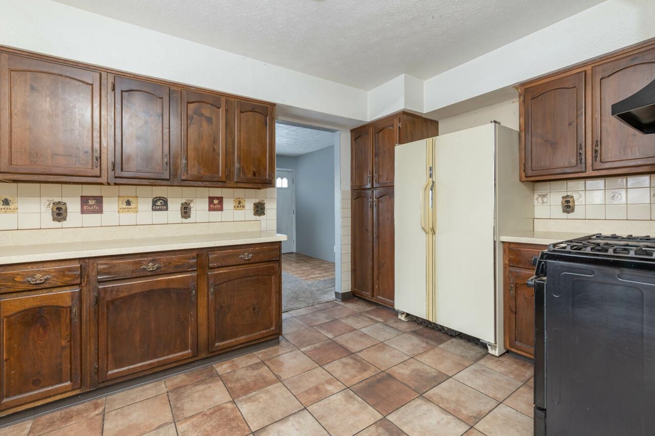7401 Randy Road Machesney Park, IL 61115 - Photo 7 of 27 a kitchen with stainless steel appliances granite countertop a refrigerator a stove and a sink