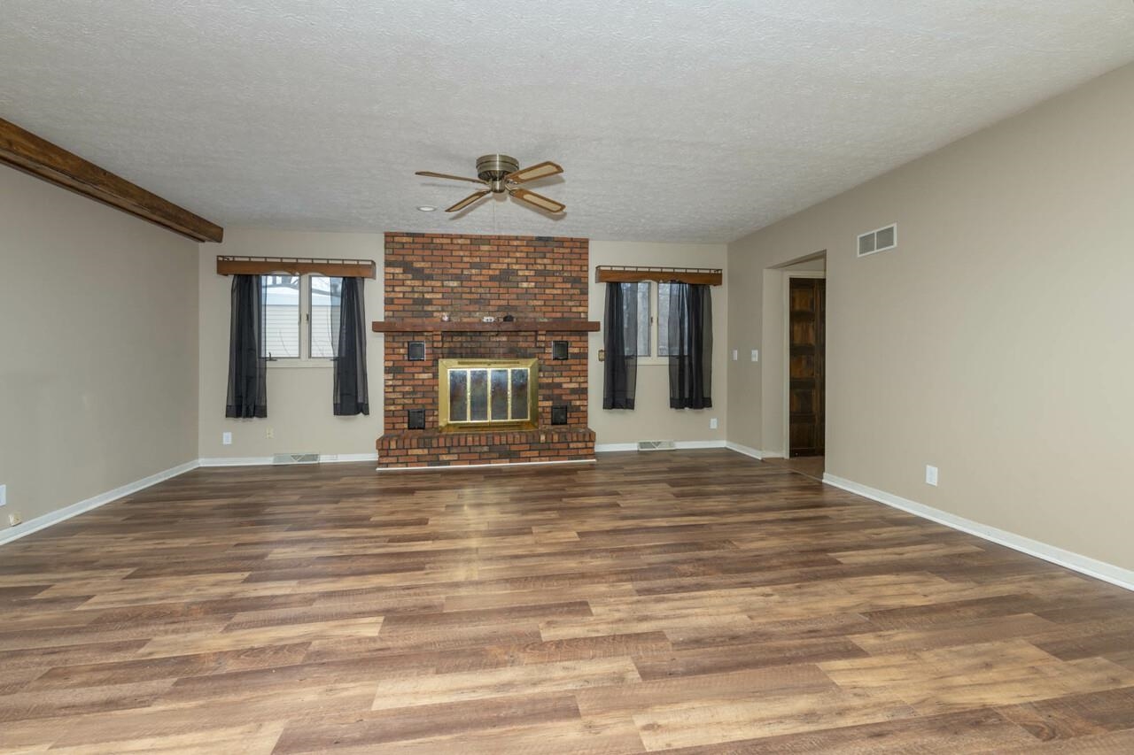 7401 Randy Road Machesney Park, IL 61115 - Photo 9 of 27 a view of empty room with wooden floor and fan