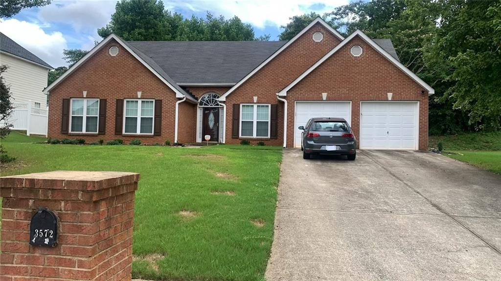 3572 Waldrop Farms Drive Decatur, GA 30034 - Photo 1 of 1 a front view of a house with a garden and plants