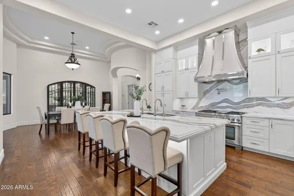 a kitchen with stainless steel appliances granite countertop a sink stove and cabinets