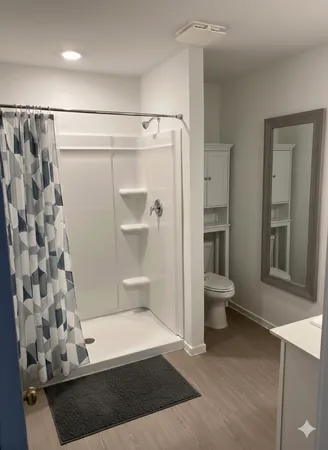 a bathroom with a shower and a toilet